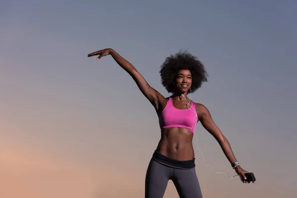 Mulher negra está fazendo alongamento exercício relaxante e aquecimento — Fotografia de Stock