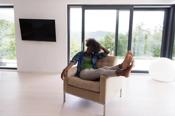 Mulher negra em casa na cadeira — Fotografia de Stock