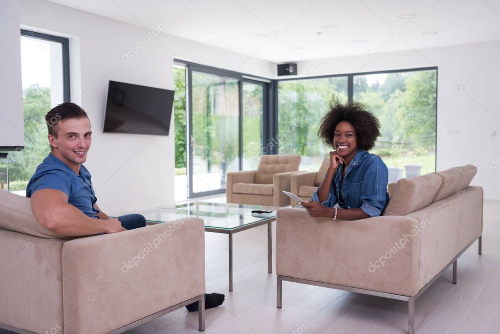 multiethnic couple in living room