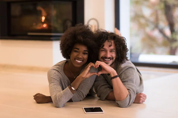 Multiethnic couple used tablet computer on the floor — Stock Photo, Image