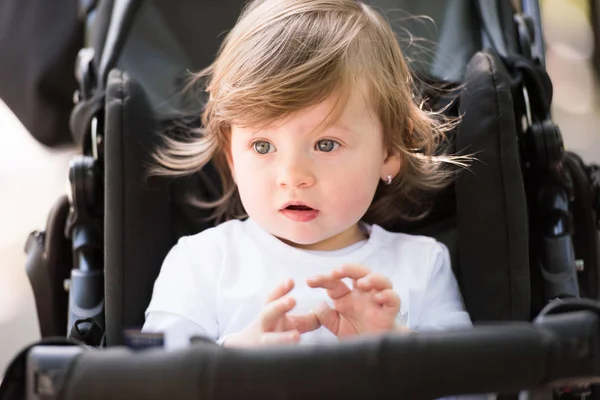 Baby girl sitting in the pram — Stock Photo, Image