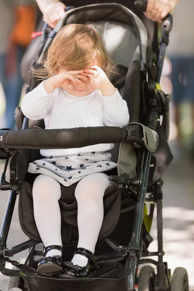 Baby girl sitting in the pram — Stock Photo, Image