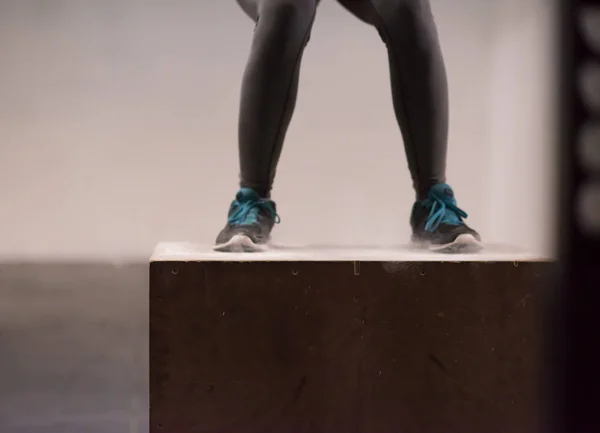 Mulher negra está realizando saltos caixa no ginásio — Fotografia de Stock