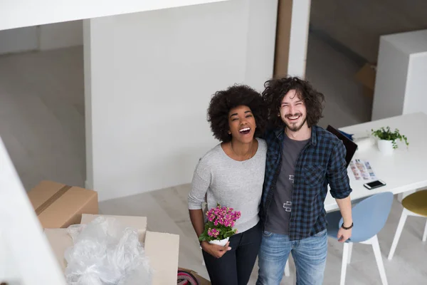 multiethnic couple moving into a new home