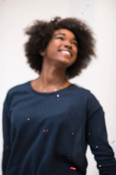 African American woman blowing confetti in the air — Stock Photo, Image