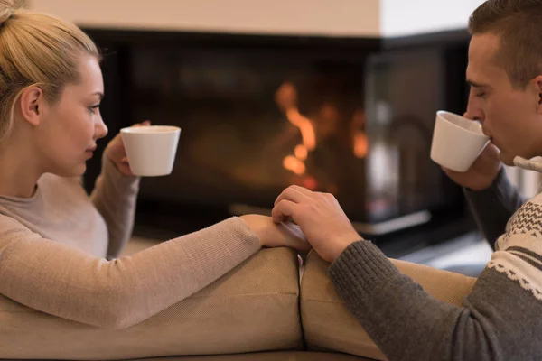 Young romantic couple sitting on sofa — Stock Photo, Image