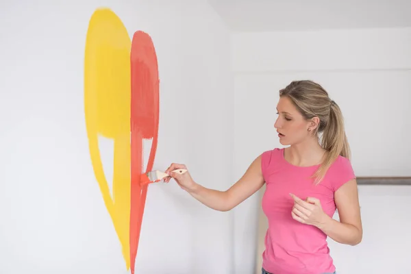 Mujer pintando un corazón en la pared —  Fotos de Stock