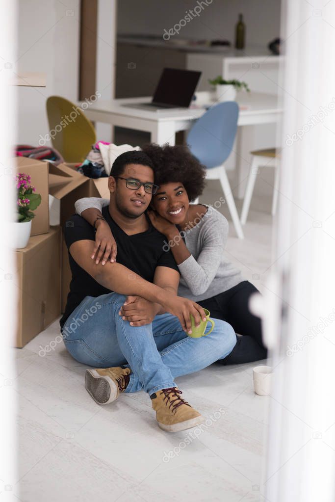 African American couple relaxing in new house