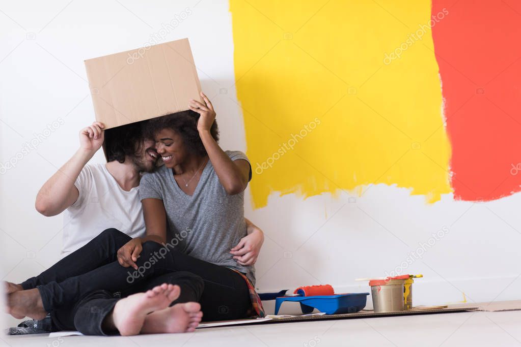 couple playing with cardboard boxes