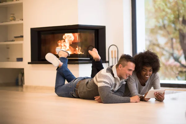 Multiethnic couple using tablet — Stock Photo, Image