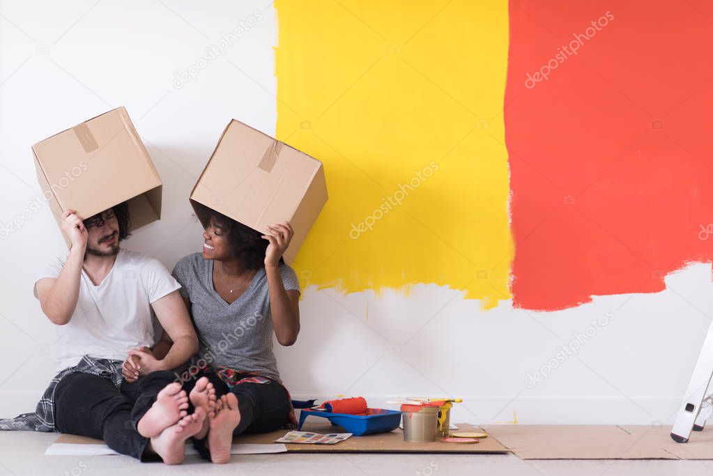 couple playing with cardboard boxes