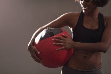 black woman carrying crossfit ball clipart