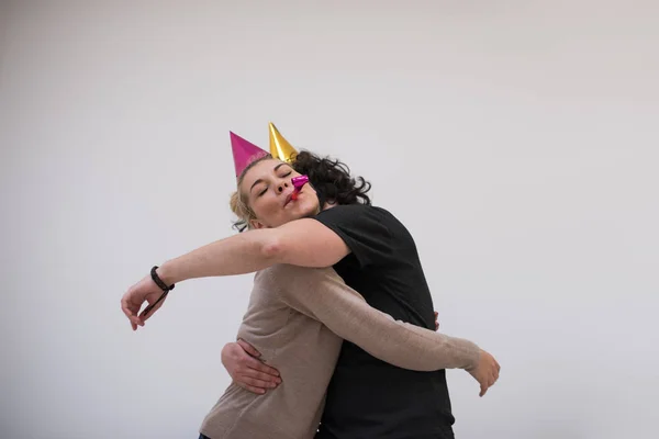 Couple dans chapeaux de fête souffler dans le sifflet — Photo