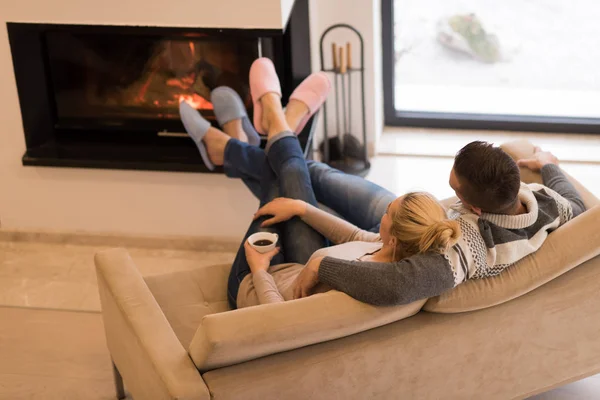 Young romantic couple sitting on sofa — Stock Photo, Image