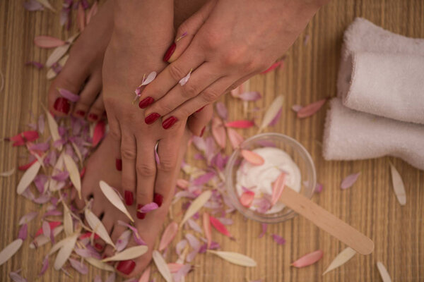 female feet and hands at spa salon