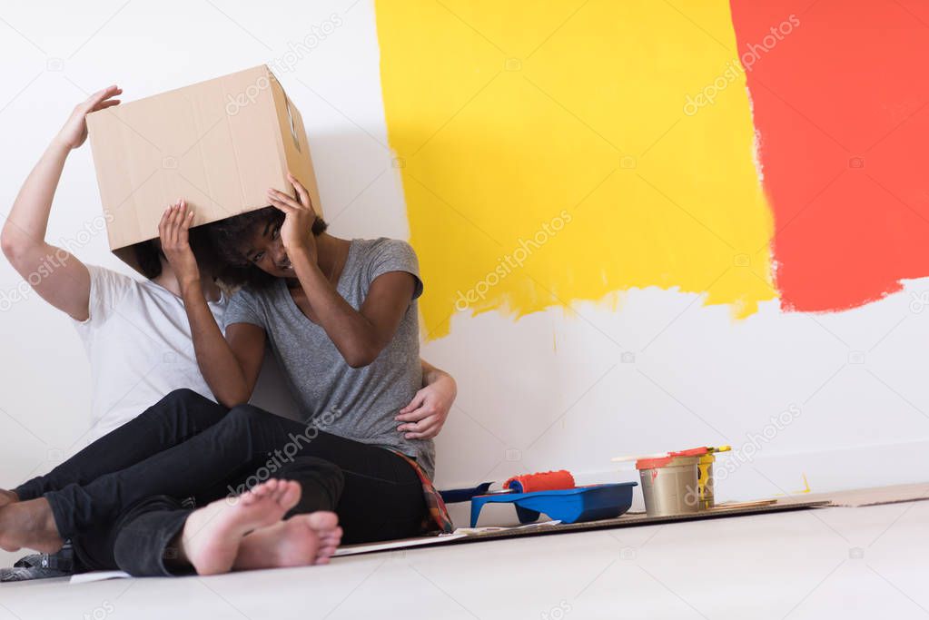 couple playing with cardboard boxes