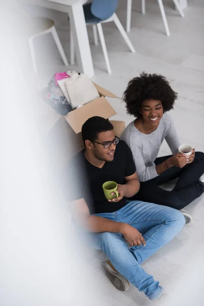 Pareja afroamericana relajándose en casa nueva — Foto de Stock