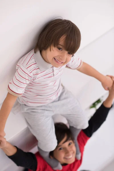 Young boys posing line up piggyback top view — Stock Photo, Image