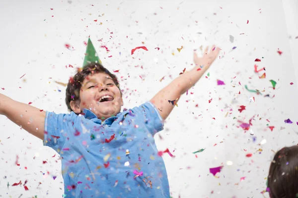 Kid blowing confetti — Stock Photo, Image