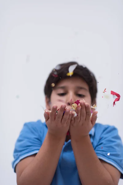 Niño soplando confeti — Foto de Stock
