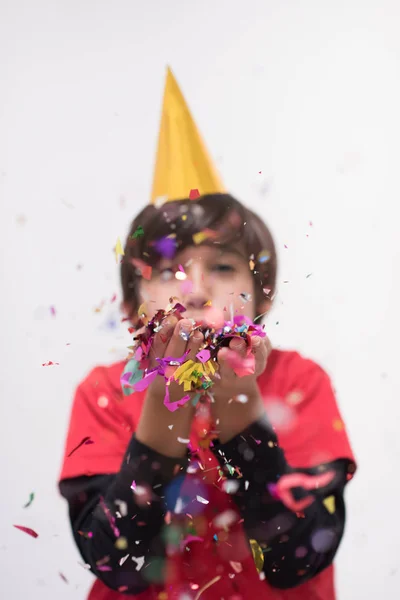 Kid blowing confetti — Stock Photo, Image