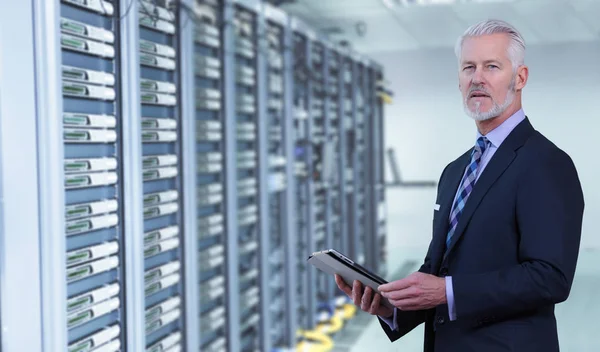 Senior businessman in server room — Stock Photo, Image