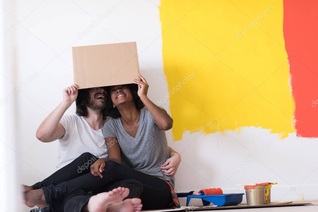 couple playing with cardboard boxes