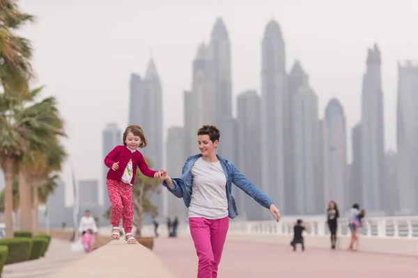 Mother and cute little girl on the promenade — Stock Photo, Image