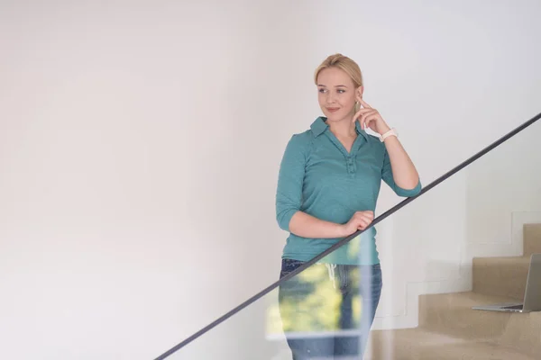 Portrait of a young beautiful woman on the stairs — Stock Photo, Image