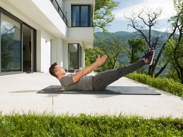 Man doing morning yoga exercises — Stock Photo, Image