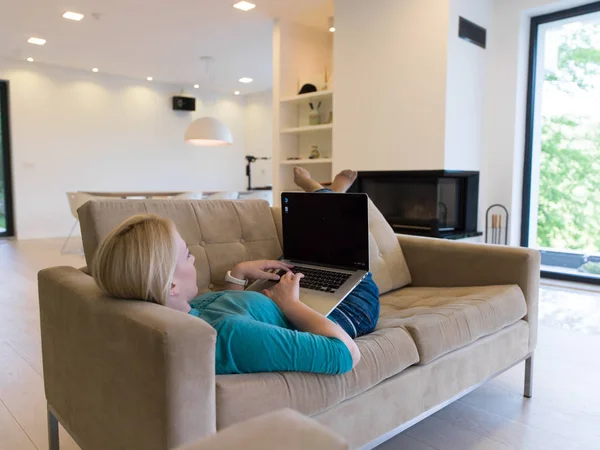 Jonge vrouw met laptop thuis — Stockfoto