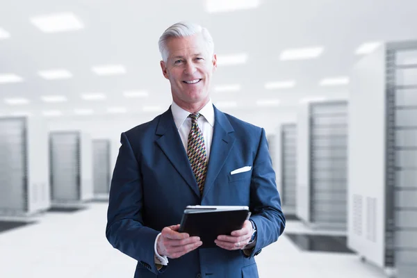 Senior businessman in server room — Stock Photo, Image