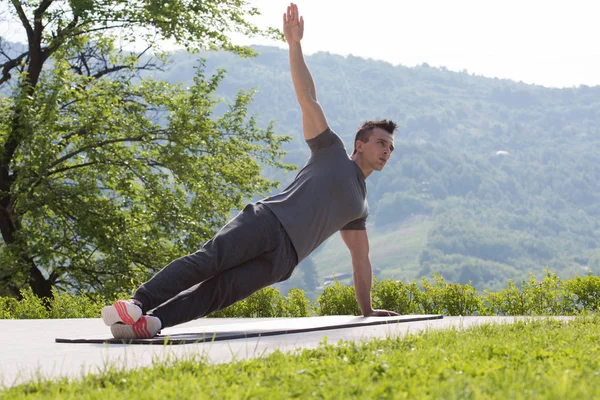 Man doing morning yoga exercises — Stock Photo, Image