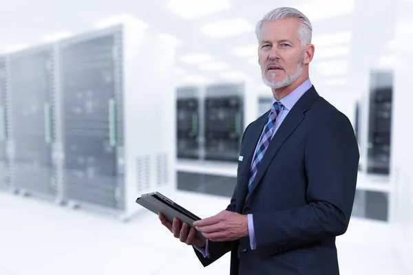 Senior businessman in server room — Stock Photo, Image