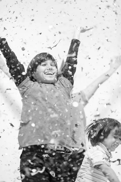 Kids  blowing confetti — Stock Photo, Image