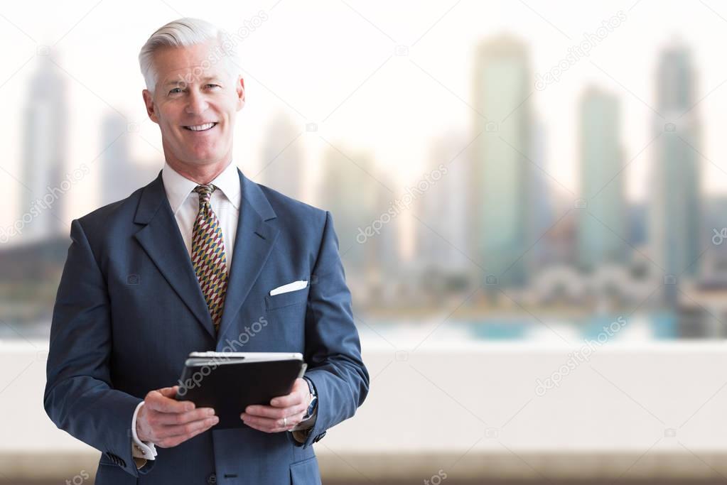 Senior businessman in front of the big city