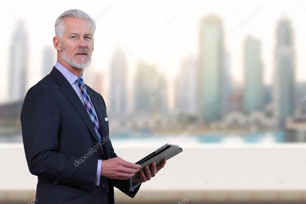 Senior businessman in front of the big city