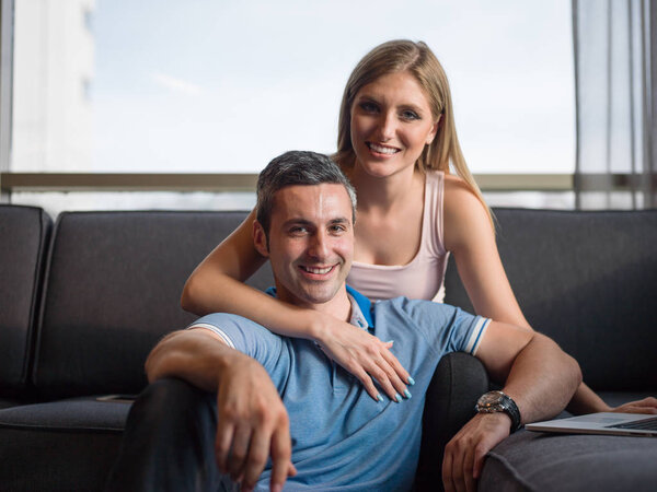 Attractive Couple Using A Laptop on couch
