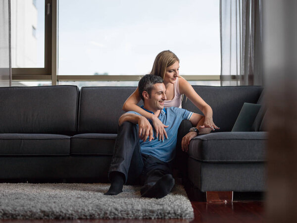 Attractive Couple Using A Laptop on couch
