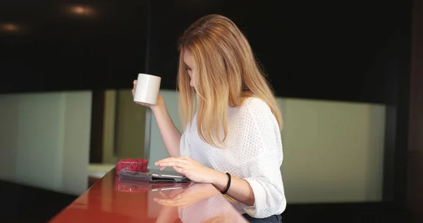 Блондинка пьет кофе наслаждаясь расслабляющим образом жизни — стоковое фото