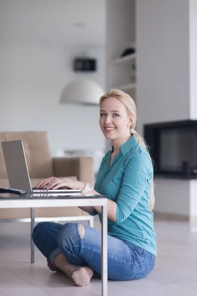 Ung kvinna använder bärbar dator på golvet — Stockfoto