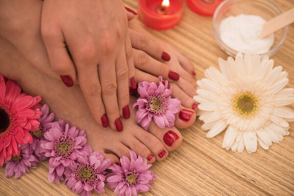 female feet and hands at spa salon