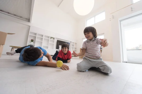 Boys having fun with an apple on the floor — Stock Photo, Image