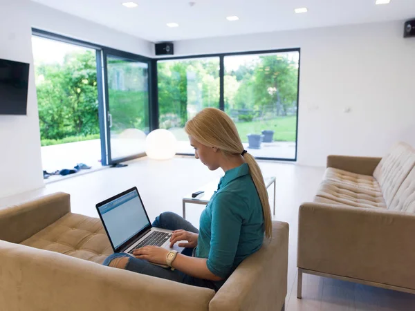 Jonge vrouw met laptop thuis — Stockfoto