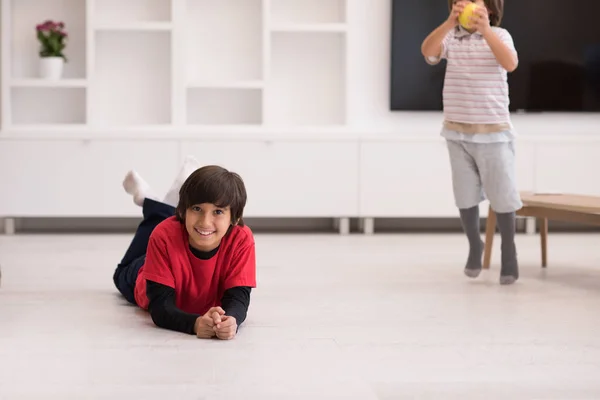 Chicos divirtiéndose con una manzana en el suelo — Foto de Stock