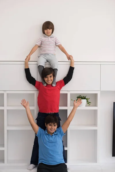 Young boys posing line up piggyback — Stock Photo, Image