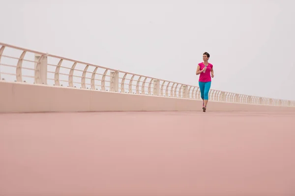 Woman busy running on the promenade — Stock Photo, Image
