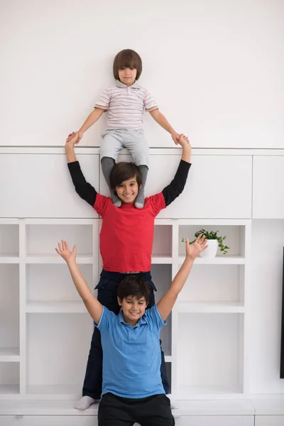 Young boys posing line up piggyback — Stock Photo, Image