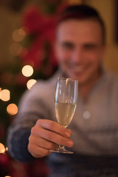 Happy young man with a glass of champagne — Stock Photo, Image
