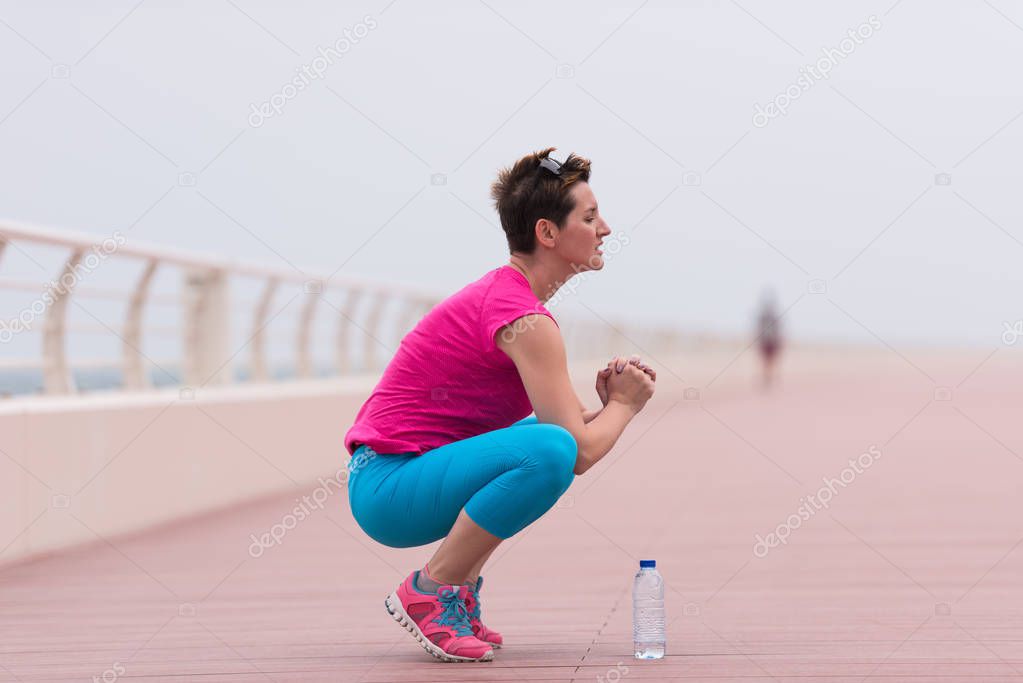 woman stretching and warming up on the promenade